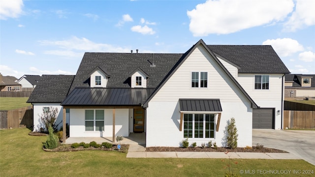 modern farmhouse style home featuring a front lawn