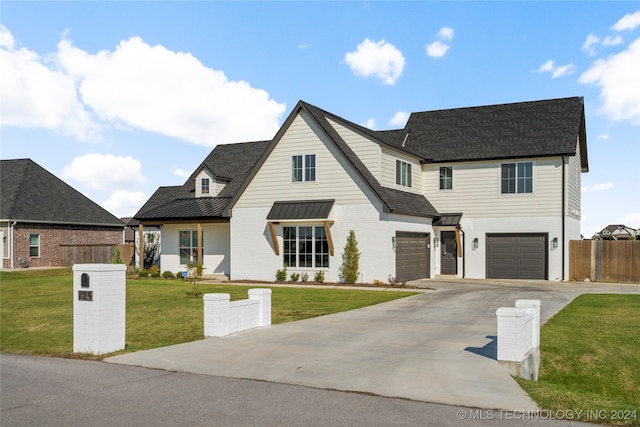 view of front facade featuring a garage and a front lawn