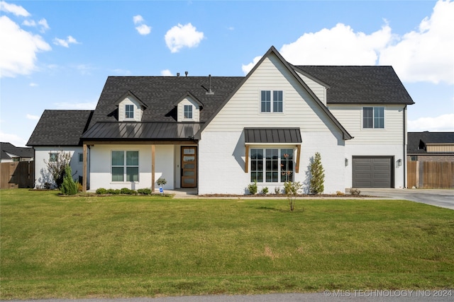 modern farmhouse featuring a garage and a front lawn