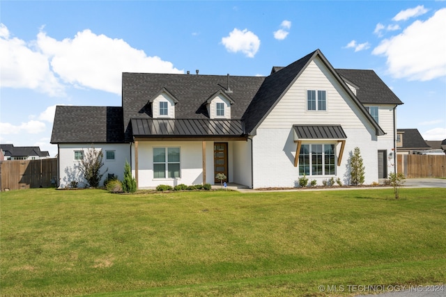 modern inspired farmhouse featuring a front lawn