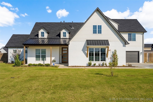 modern farmhouse style home featuring a garage and a front yard