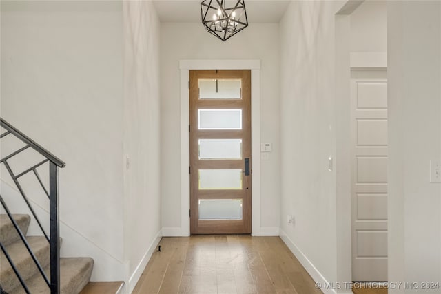 entrance foyer with light wood-type flooring and a chandelier