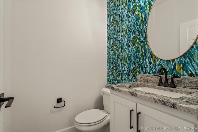 bathroom with vanity and toilet