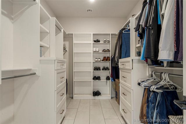 spacious closet featuring light tile patterned flooring