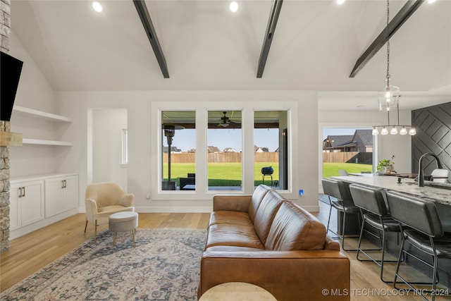 living room featuring lofted ceiling with beams, ceiling fan, and light hardwood / wood-style floors