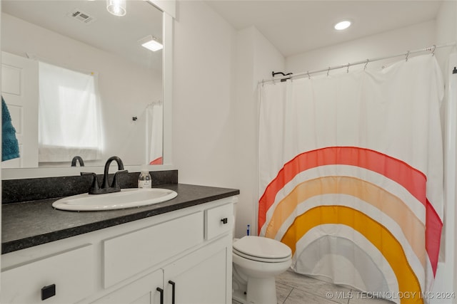 bathroom featuring toilet and vanity