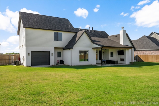 rear view of property featuring central AC unit, a lawn, and a patio area