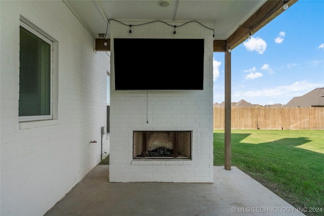 view of patio / terrace featuring an outdoor brick fireplace