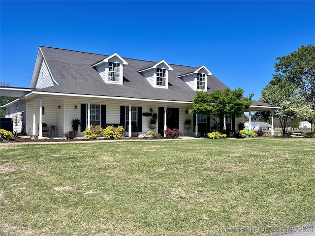 new england style home featuring a front yard and covered porch