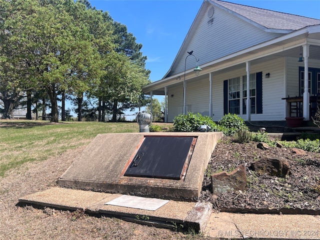 view of storm shelter featuring a lawn