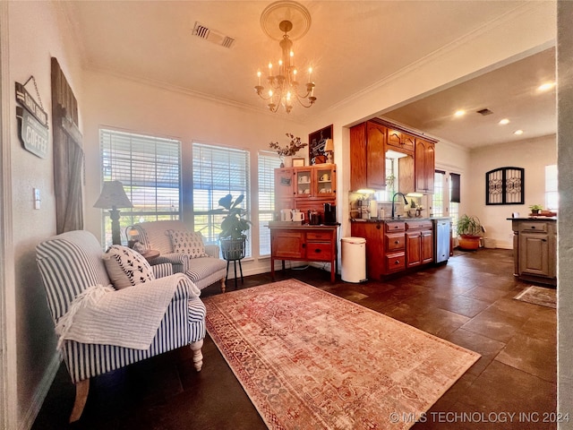 living room with ornamental molding, sink, and a chandelier