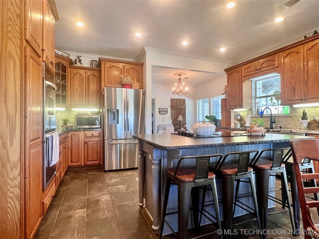 kitchen featuring backsplash, a breakfast bar area, appliances with stainless steel finishes, and ornamental molding