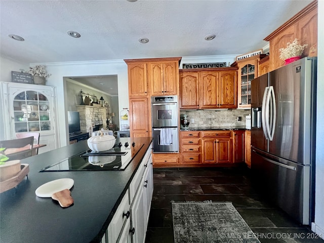 kitchen featuring ornamental molding, decorative backsplash, and stainless steel appliances