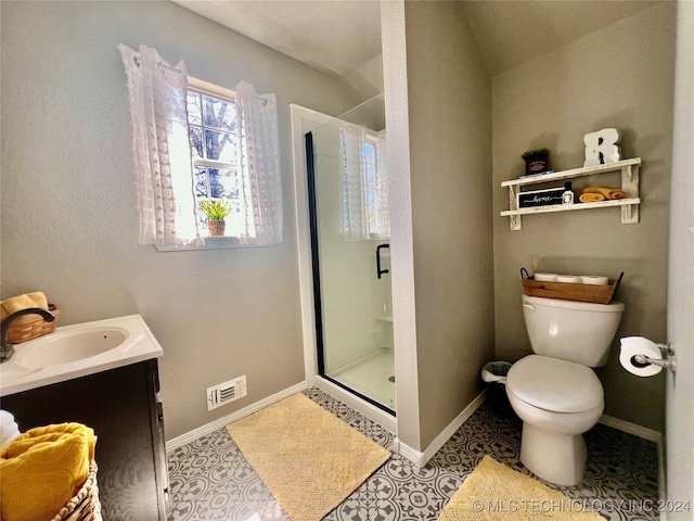 bathroom with vanity, tile patterned flooring, vaulted ceiling, an enclosed shower, and toilet