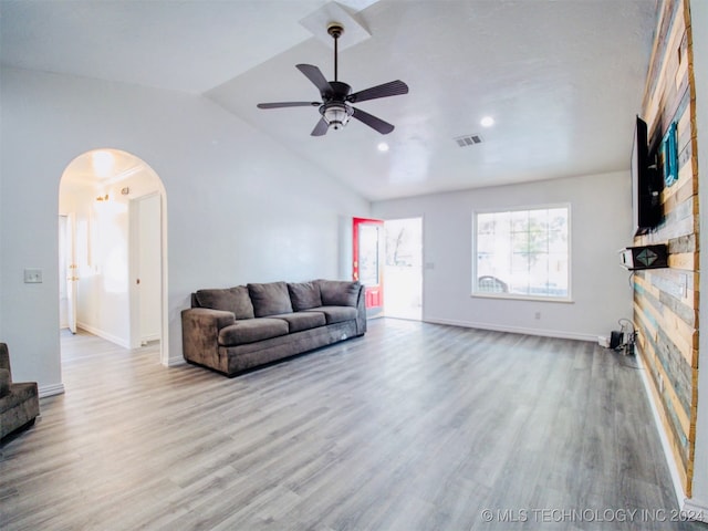 living room with lofted ceiling, light hardwood / wood-style floors, and ceiling fan