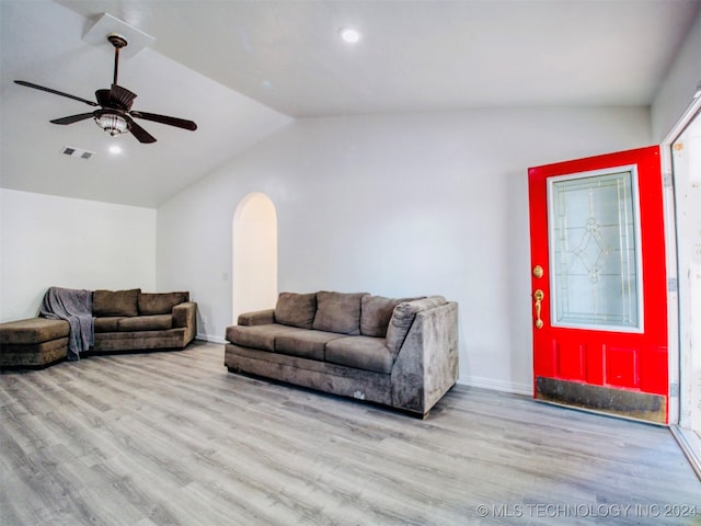 living room with lofted ceiling, light wood-type flooring, and ceiling fan