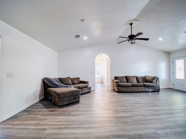 living room featuring ceiling fan, vaulted ceiling, and light hardwood / wood-style flooring