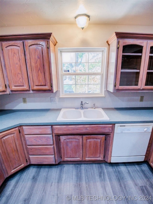 kitchen featuring backsplash, dark hardwood / wood-style flooring, sink, and dishwasher