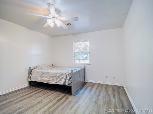 bedroom featuring light hardwood / wood-style flooring and ceiling fan