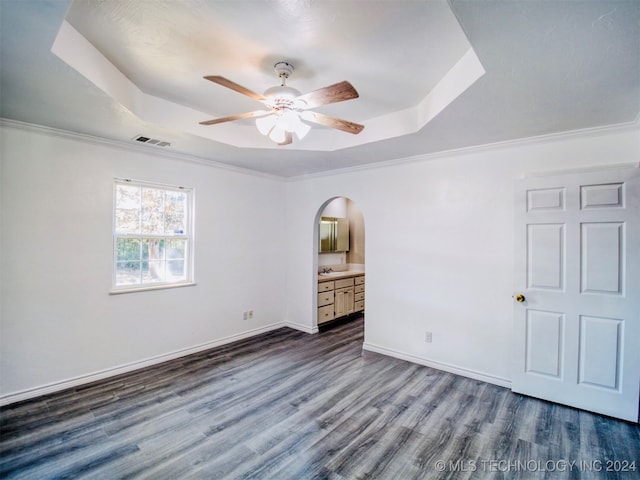 unfurnished bedroom featuring ornamental molding, ceiling fan, and wood-type flooring