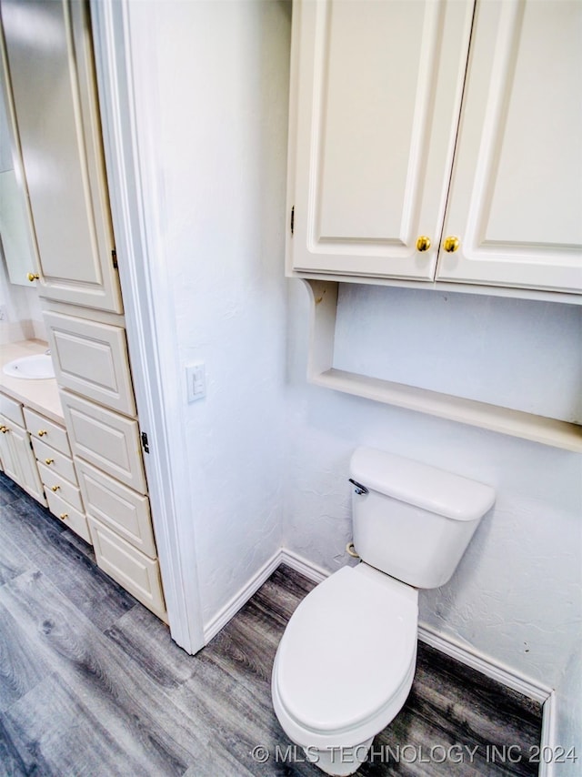 bathroom featuring hardwood / wood-style flooring, toilet, and vanity