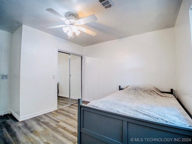 bedroom with ceiling fan, hardwood / wood-style flooring, and a closet