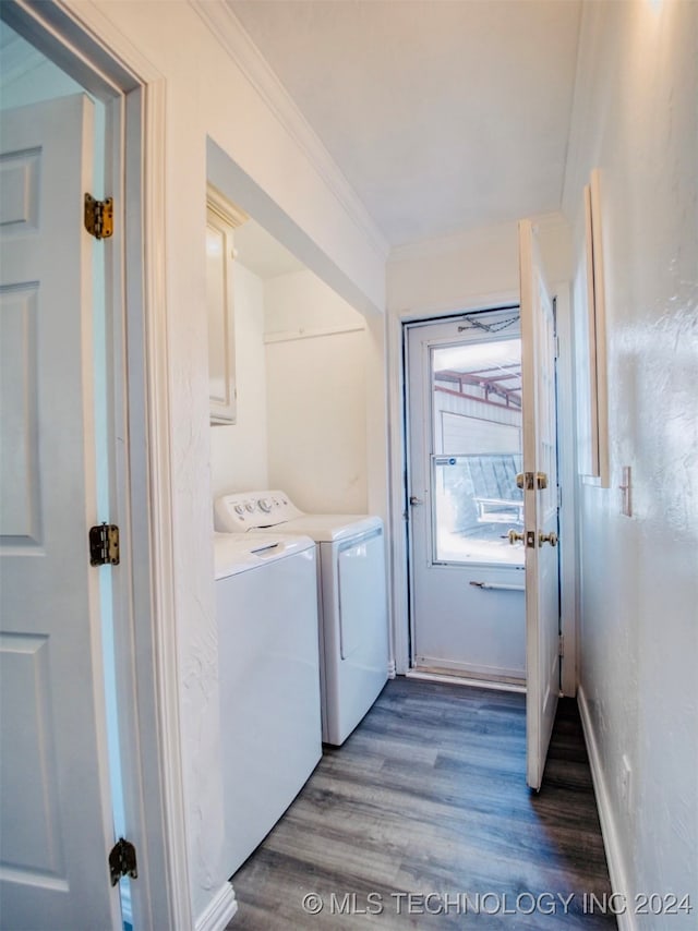 washroom with ornamental molding, washer and dryer, and hardwood / wood-style floors