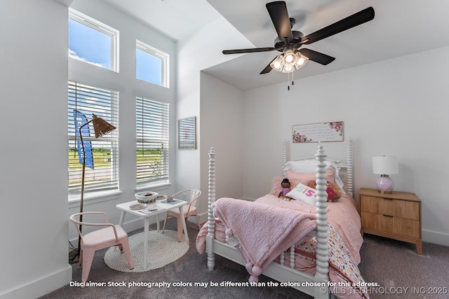 bedroom with baseboards, dark carpet, and ceiling fan