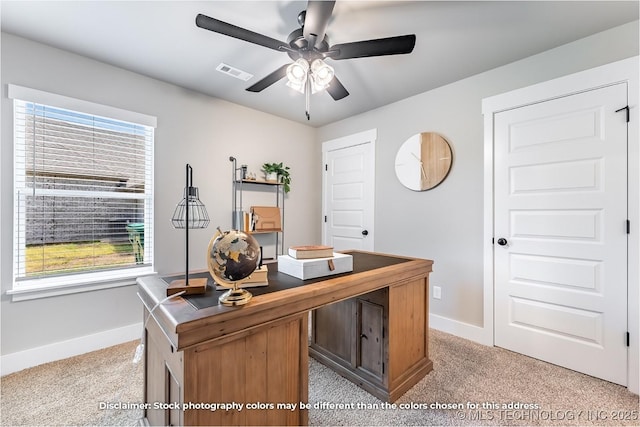 office area featuring ceiling fan, light carpet, visible vents, and baseboards