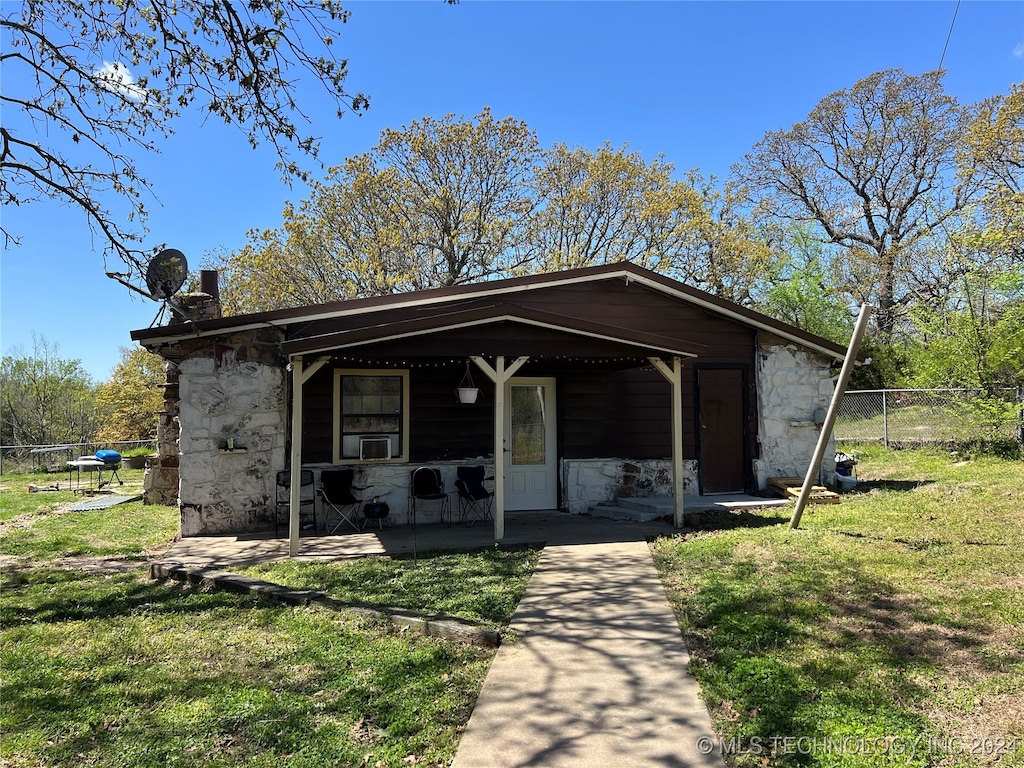 bungalow-style home featuring a front yard