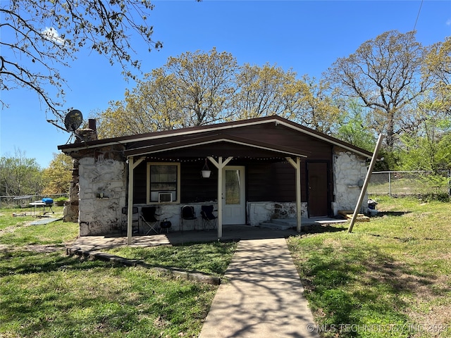 bungalow-style home featuring a front yard