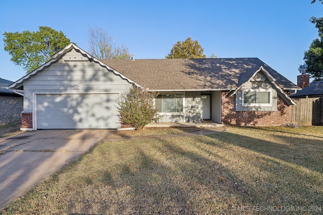 ranch-style home featuring a front lawn and a garage