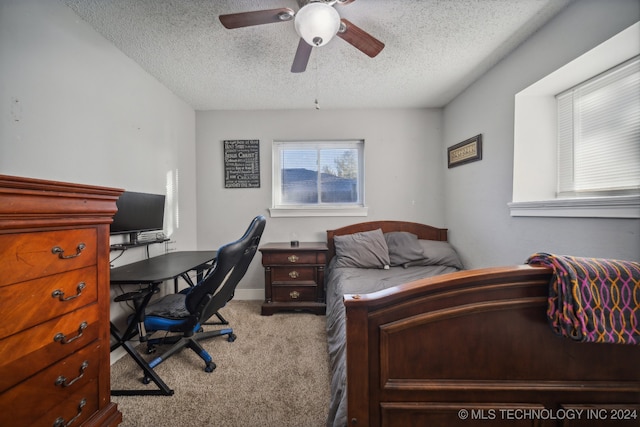 carpeted bedroom with a textured ceiling and ceiling fan