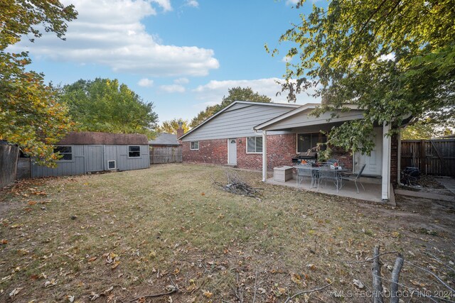 view of yard with a storage unit and a patio area