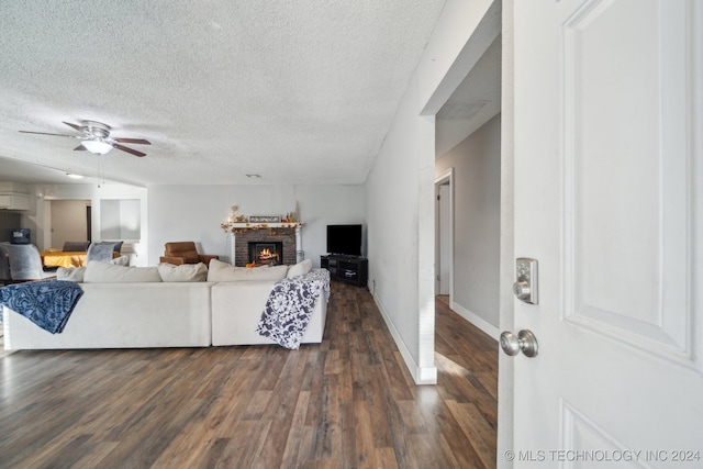 living room with dark hardwood / wood-style floors, a textured ceiling, vaulted ceiling, and ceiling fan