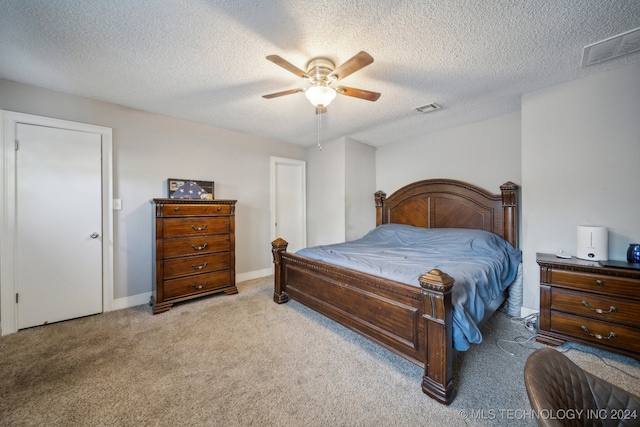 bedroom featuring ceiling fan, a textured ceiling, and light colored carpet