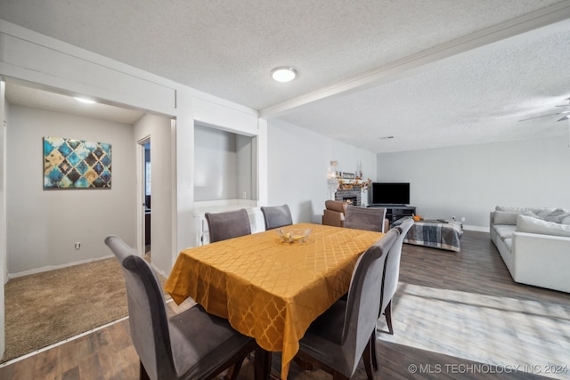 dining room featuring a textured ceiling, hardwood / wood-style flooring, and ceiling fan