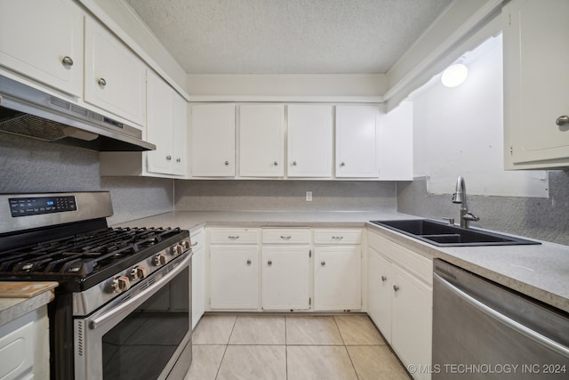 kitchen featuring sink, white cabinetry, stainless steel appliances, and a textured ceiling