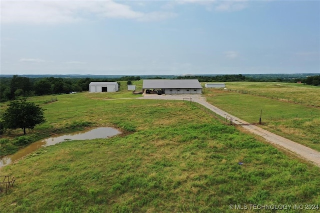 view of yard featuring an outbuilding and a rural view