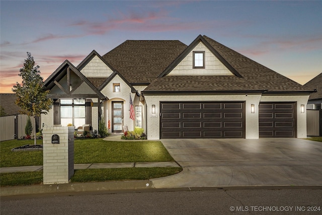 view of front facade featuring a lawn and a garage