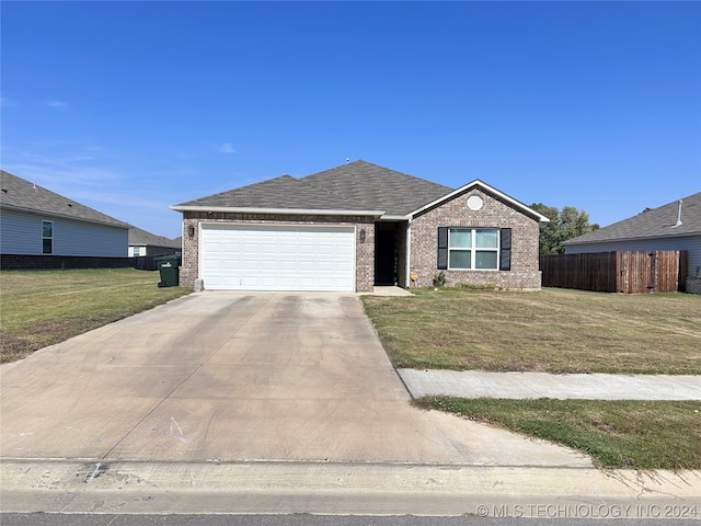 view of front of property with a front yard and a garage