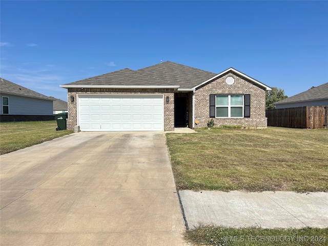 single story home featuring a garage and a front lawn