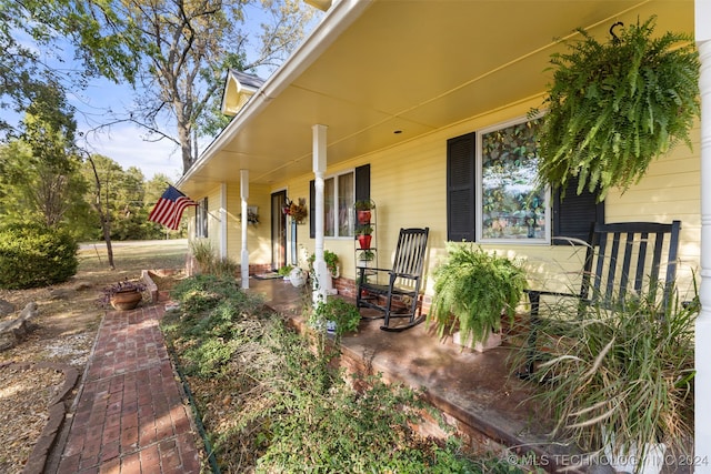 view of exterior entry featuring a porch