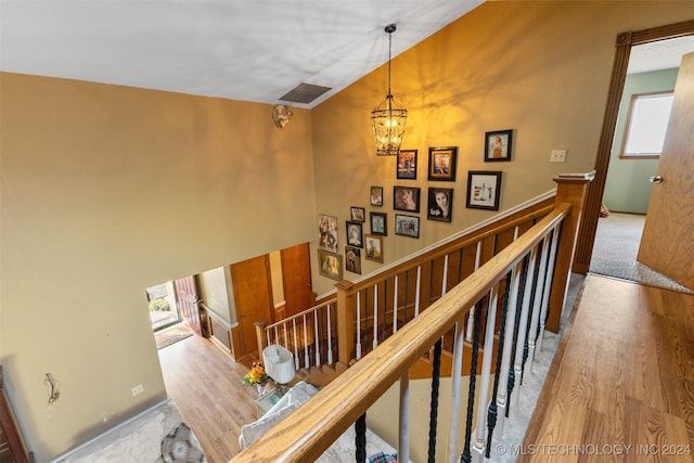 stairway featuring a notable chandelier and hardwood / wood-style floors