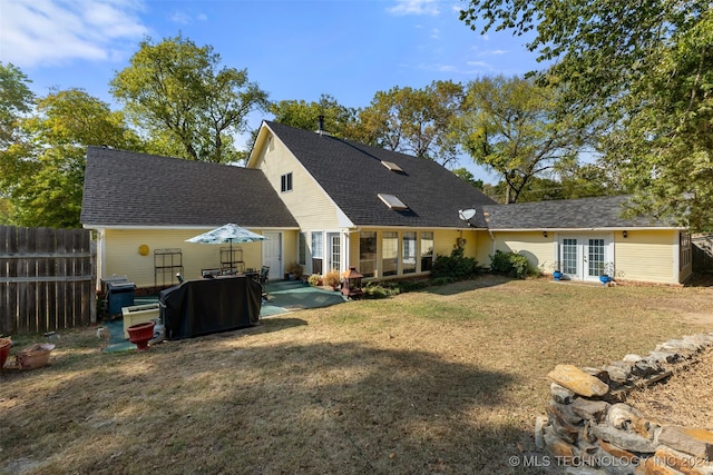 rear view of property featuring a yard and a patio area