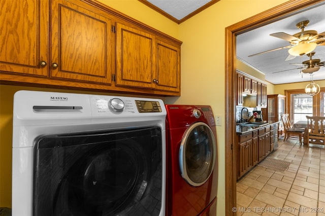 laundry area featuring sink, crown molding, separate washer and dryer, cabinets, and a textured ceiling