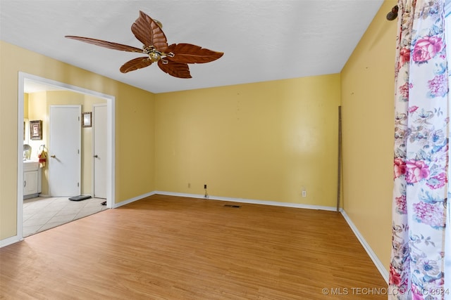 unfurnished room with ceiling fan and light hardwood / wood-style flooring