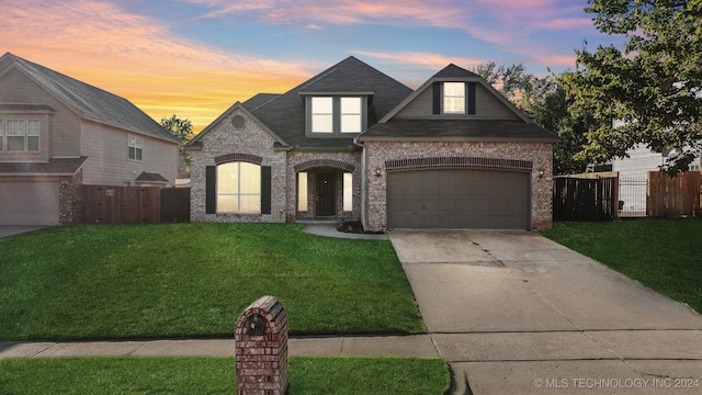 view of front of property with a lawn and a garage