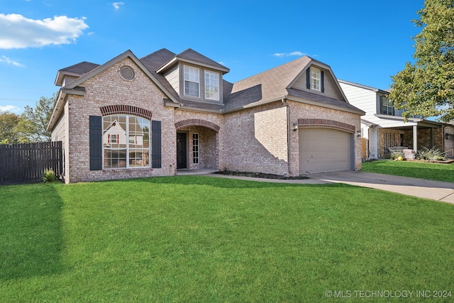 view of front of home featuring a front yard and a garage