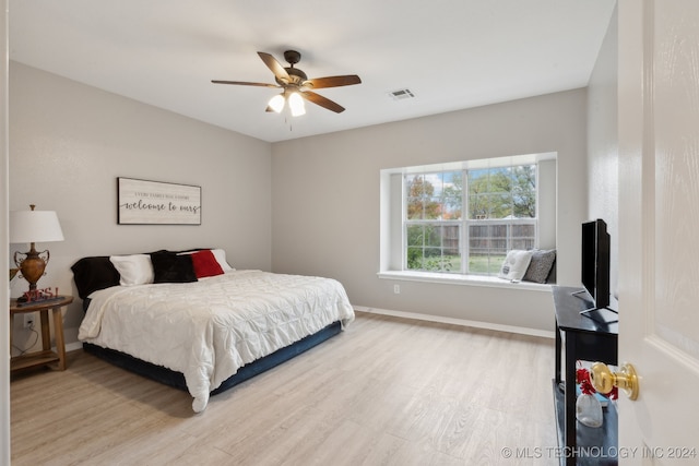 bedroom with ceiling fan and light wood-type flooring